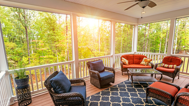 screened-in porch with patio furniture