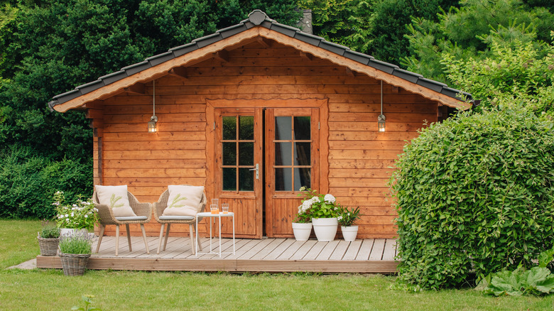 a wooden shed with porch