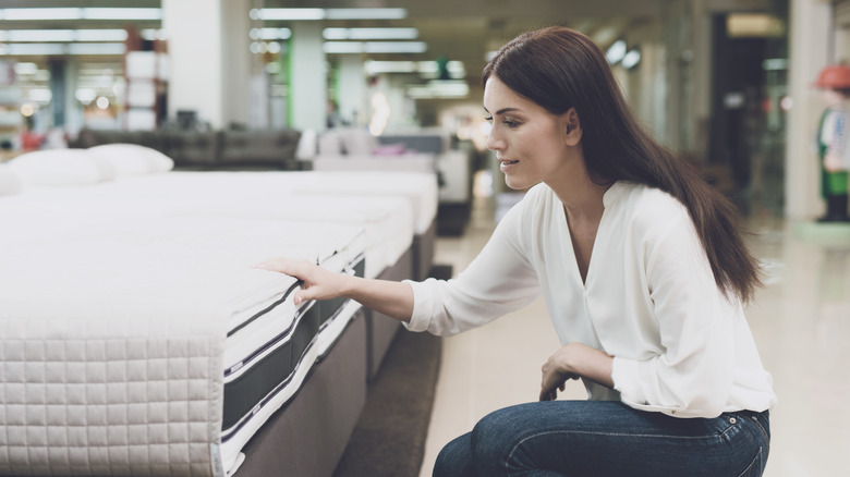 Woman shopping for mattress
