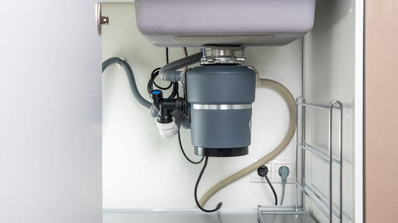 Grey garbage disposal under sink