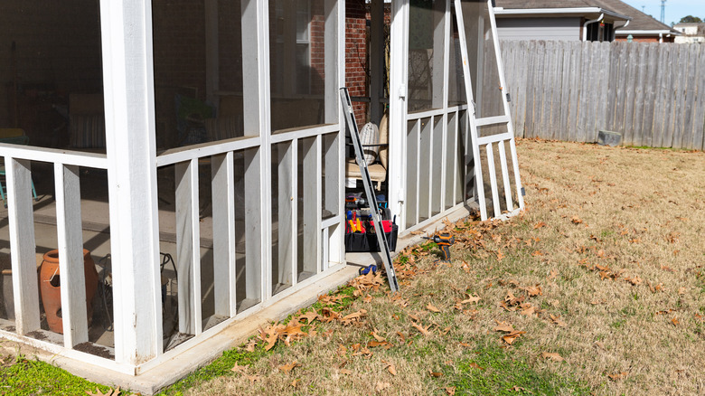 Construction of screen around porch