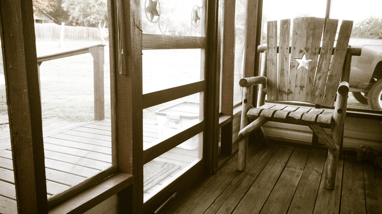 Wooden chair inside screened porch