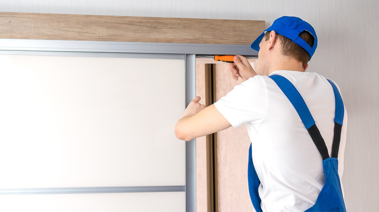 technician installing sliding door