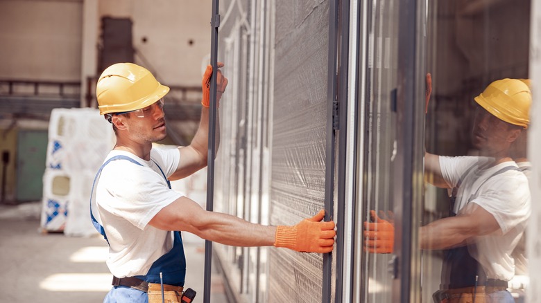 worker installing sliding door