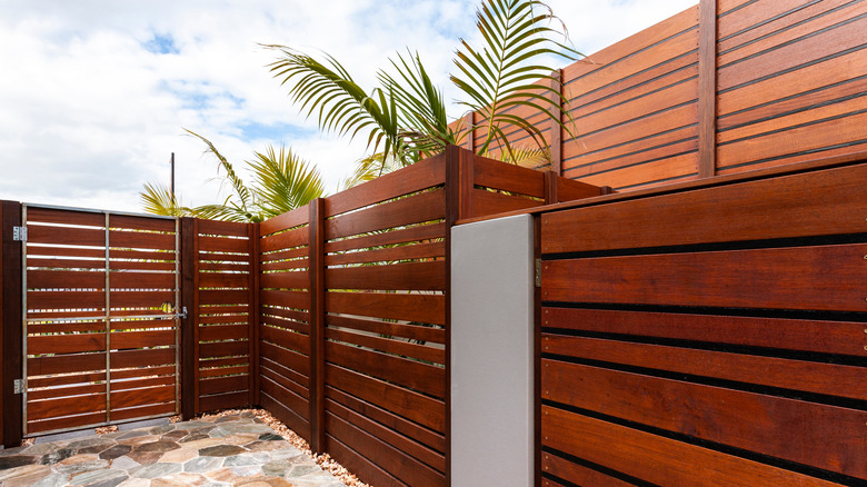 Wooden fence enclosing palm trees