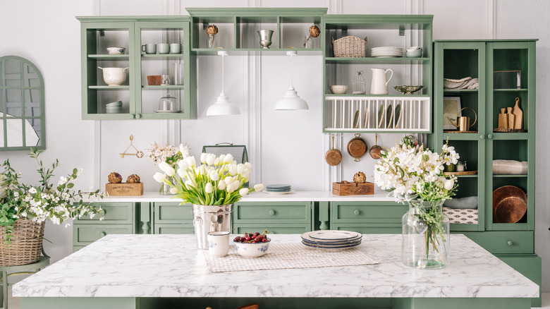 Marble counters with green cabinets