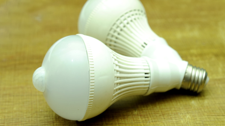 A white motion sensor bulb fixture with two bulbs