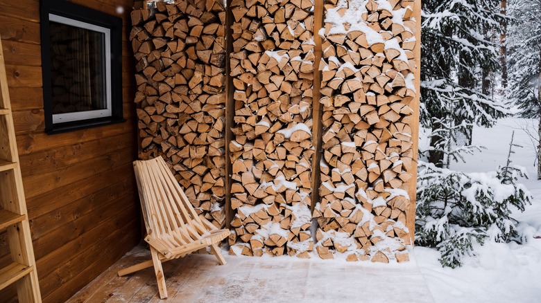 Neatly stacked firewood in snow