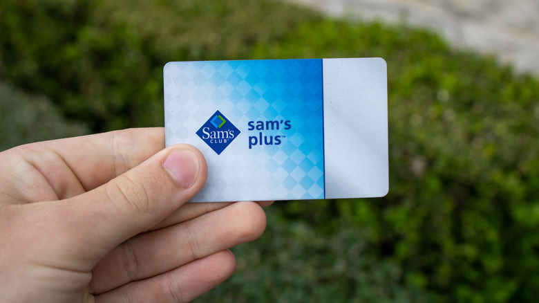 hand holding sam's plus card