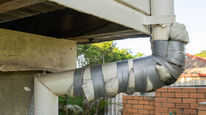 Gutter pipe repaired with tape