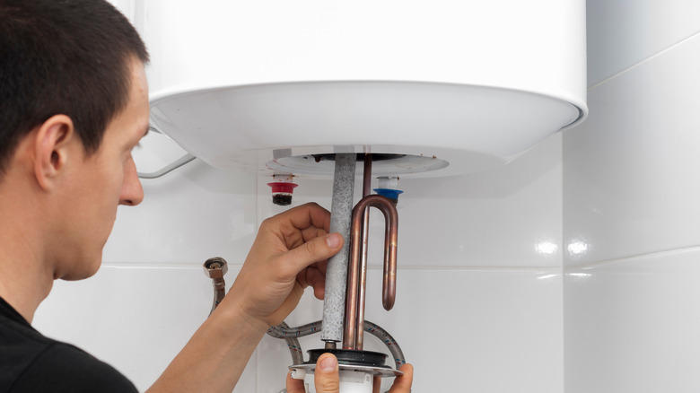 Technician fixing water heater