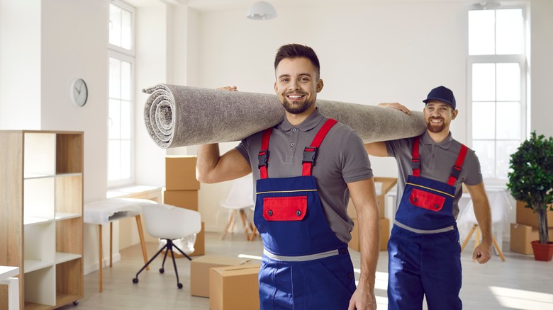 Movers moving a rug