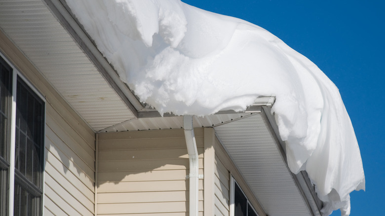 Heavy snow overhanging the edge of a house roof