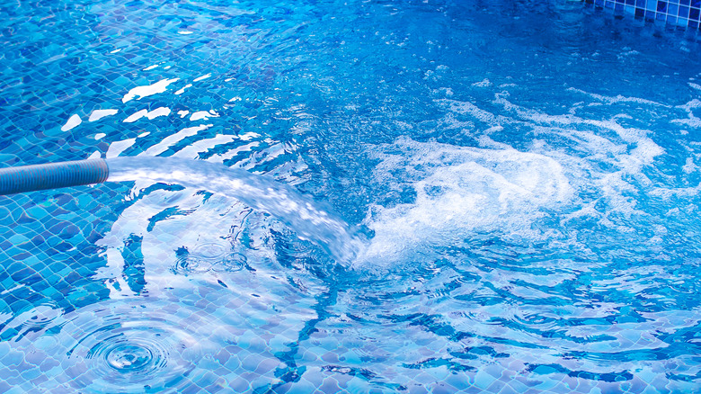 Blue hose filling pool