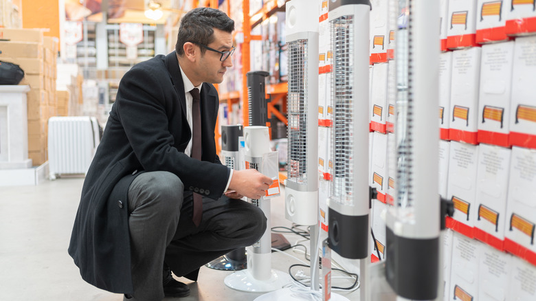 Man shopping for a space heater in a store