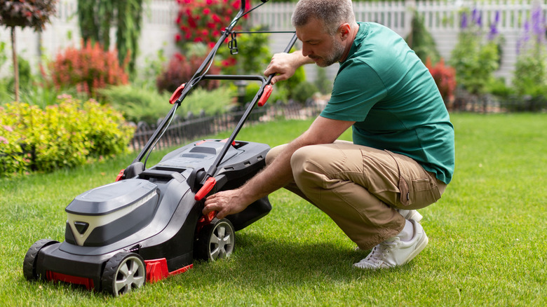 person fixing a lawnmower