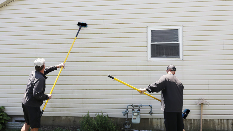 Cleaning exterior siding with brushes