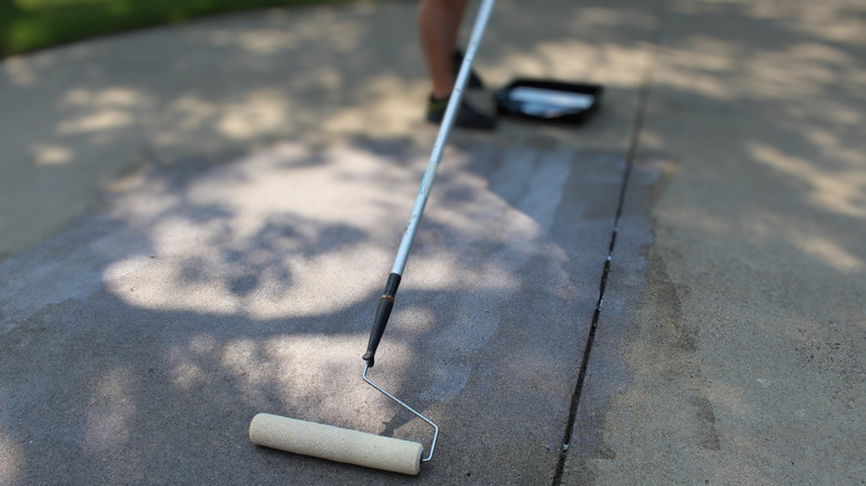 Roller is used to apply sealant to concrete surface