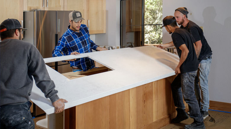 men installing marble countertop