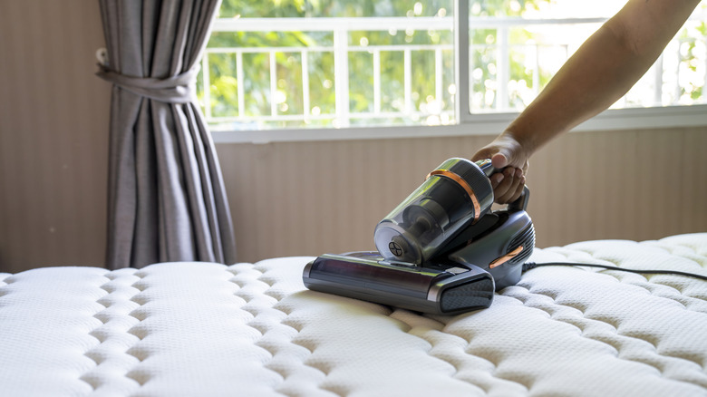 Someone vacuuming their mattress