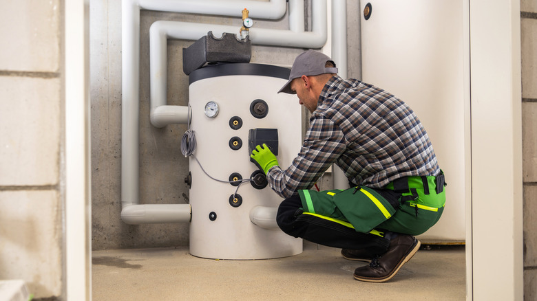 A man installing a hot water heater