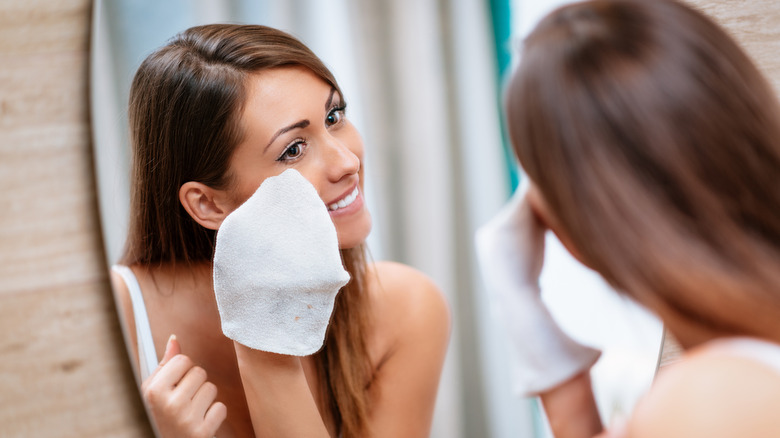 Person washing face with washcloth