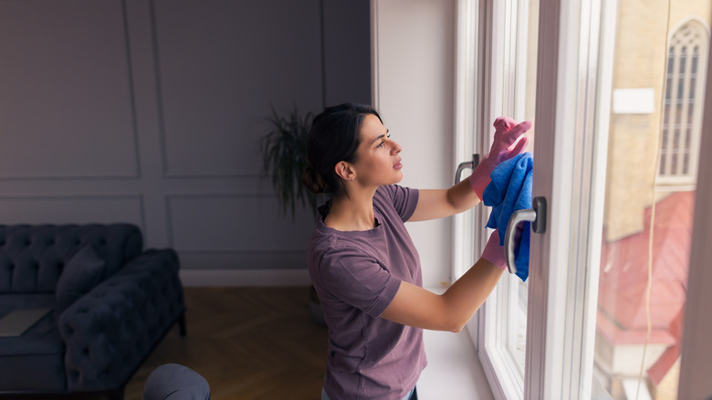 Person cleaning windows with cloth