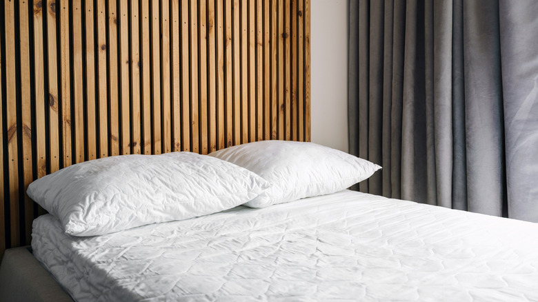 White bare bed with a memory foam topper