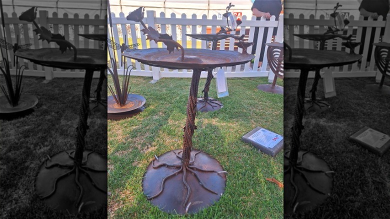 A bird bath among other metal sculptures made by Adrian Beacham.