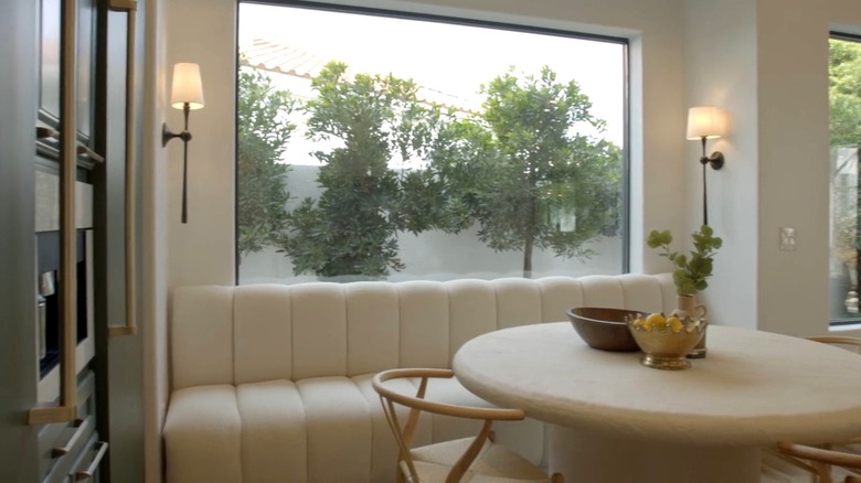 Row of small evergreen trees outside of a window