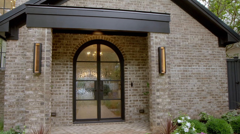 Black french doors with rounded top and textured, frosted glass
