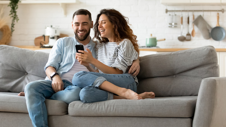 Couple on couch inside apartment