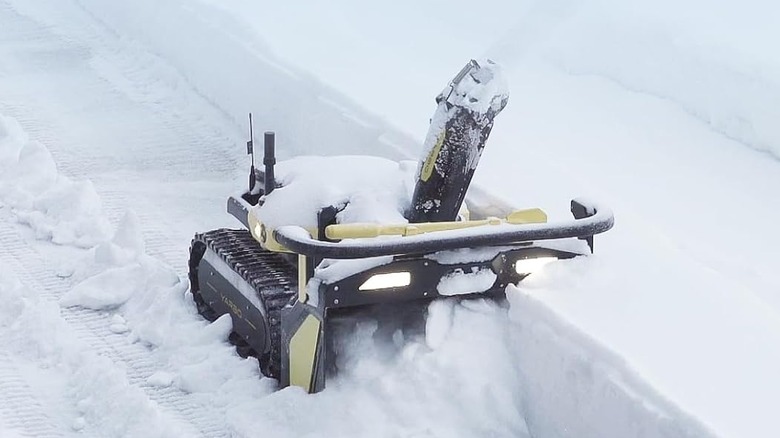 The Yarbo robotic snow blower clearing a yard