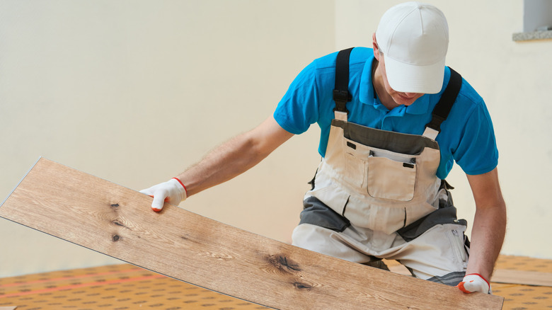 Man installing vinyl flooring
