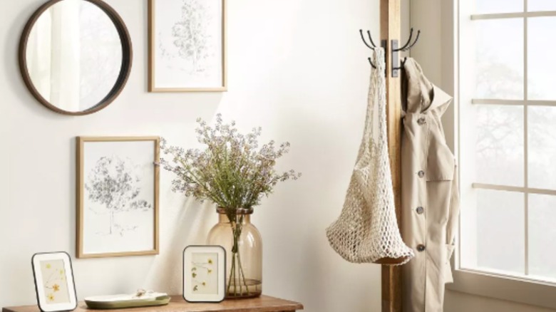 Wood coat rack from Hearth & Home with Magnolia in use in an entryway