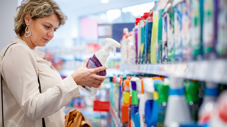 A person shopping for household cleaning products at a grocery store