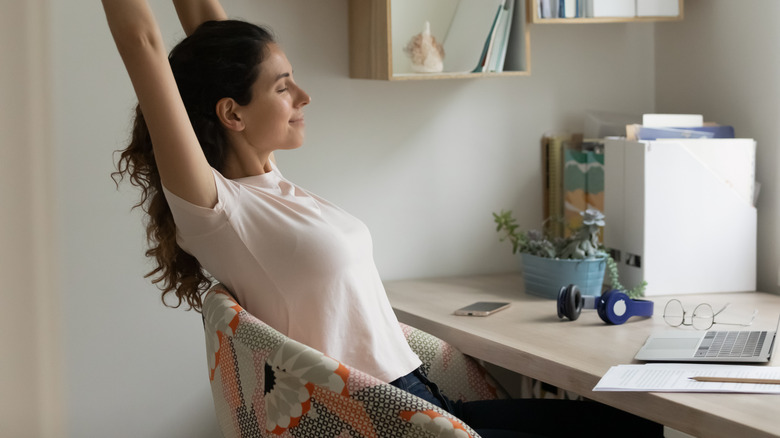 Woman stretching at desk