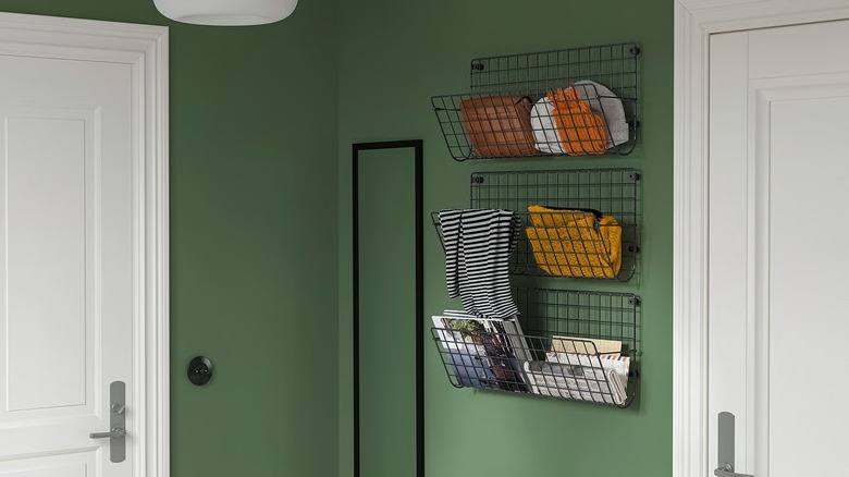 IKEA's GREJIG wall pockets installed on a green wall in hallway