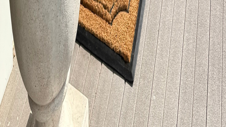 monogrammed door mat between planters
