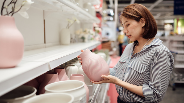 Someone shopping for a pink vase