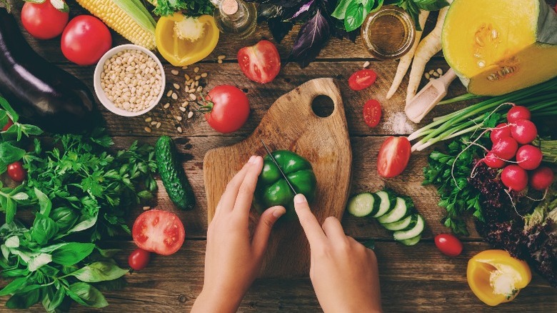 vegetables surrounding wood cutting board