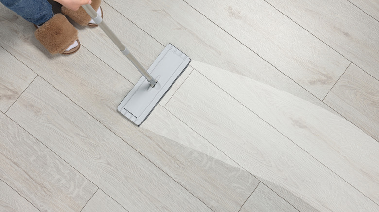 A person mopping laminate floor