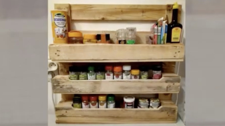 A rustic kitchen storage shelf made from pallet wood