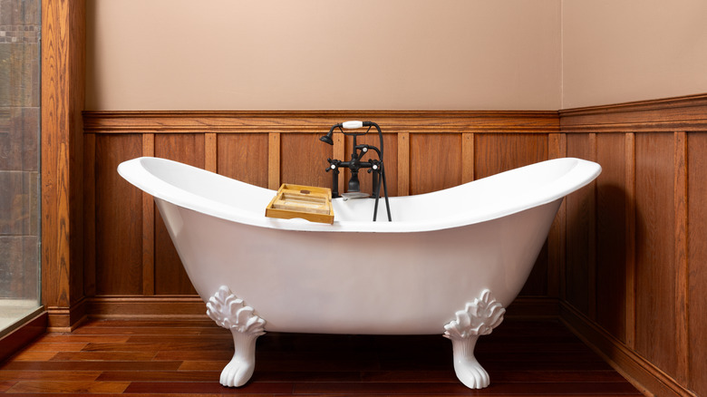 A classical-styled bathroom with wainscoting around the wall