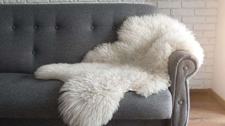 sheepskin rug on gray couch