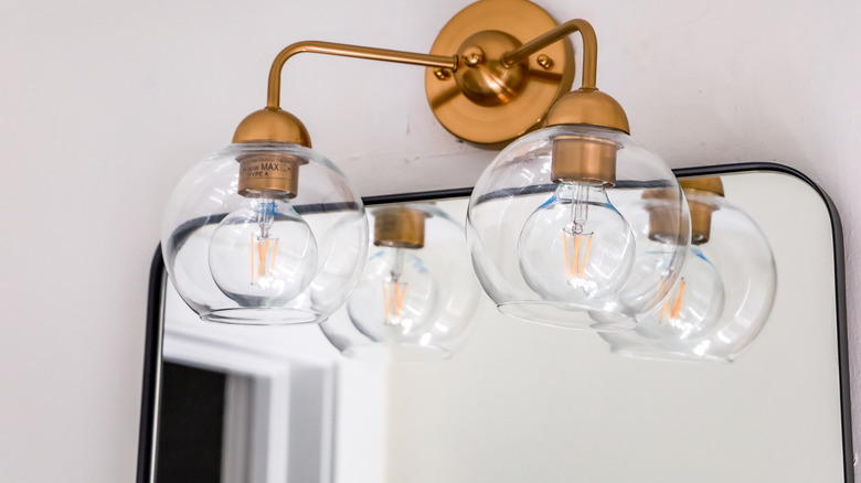 classic globe fixtures over mirror