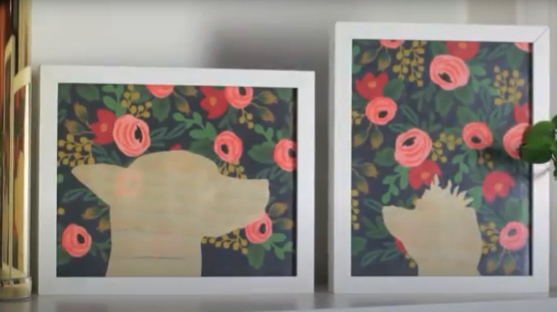 Two silhouette portraits of dogs on flowered backgrounds
