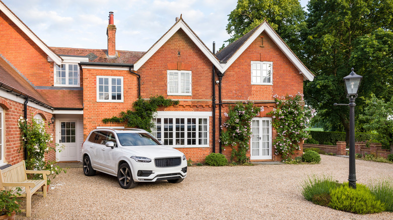 Luxury house with a car parked on the gravel drive