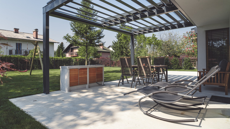 Concrete patio with black pergola
