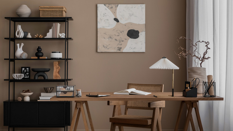 A home office with light-filtering curtains next to a desk